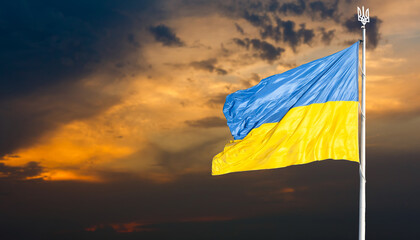 Flag of Ukraine against the backdrop of sunrise. Yellow-blue flag of independent Ukraine.