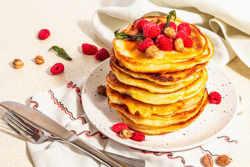 Classic homemade American pancakes with frozen raspberries, hazelnut and mint. Healthy breakfast