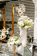 wedding decor of white flowers for the ceremony on the street