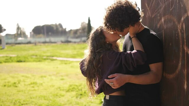 romance, love - young embraced couple in love kissing at park