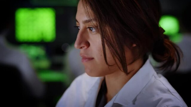 Close up of Female Medical Research Scientist using computer laptop. Neurologist Solving Puzzles of the Mind and Brain. In the Laboratory with Multiple Screens Showing Images