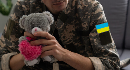 Ukrainian man warrior dressed in a military pixel uniform the yellow-blue flag of Ukraine