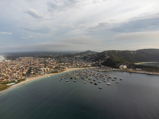 Anjos beach with many boats and houses in Arraial do Cabo, Rio de Janeiro, Brazil. Aerial drone view.