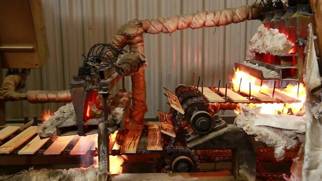 Semi-automatic machine for brushing wooden parts with an open fire. The wood treated with fire becomes less combustible and is practically not subject to rotting and spoilage by insects.