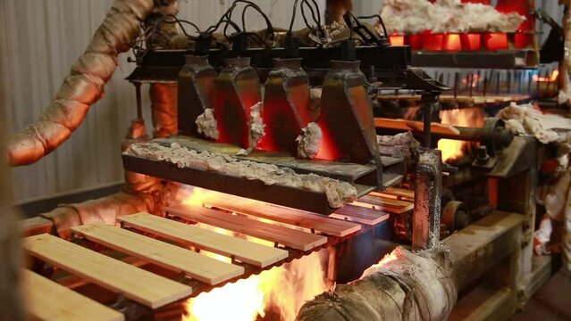 Semi-automatic machine for brushing wooden parts with an open fire. The wood treated with fire becomes less combustible and is practically not subject to rotting and spoilage by insects.