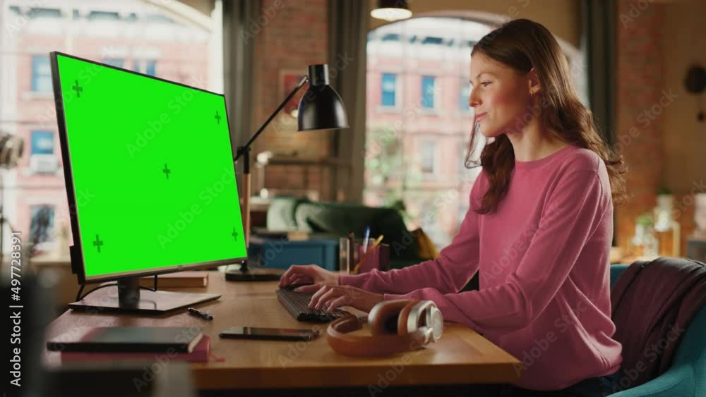 Aufkleber young pretty female working from home on desktop computer with green screen mock up display. creativ