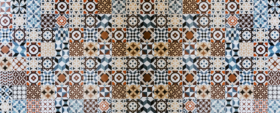 A Wall Of Traditional Ornamental Mosaic Square Tiles With Colorful Patterns Over White Background. Ideal for kitchen or wall decoration.