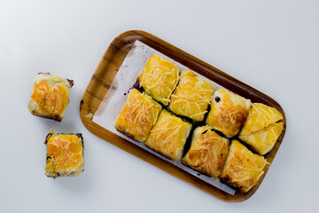 Banana Bolen or Banana Wrap with Puff Pastry. Usually given cheese topping.