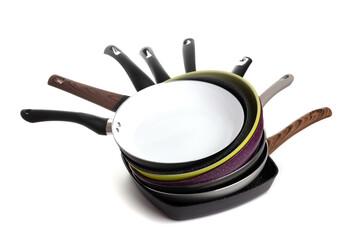 stack of modern stylish multicolored non-stick frying pans on white background