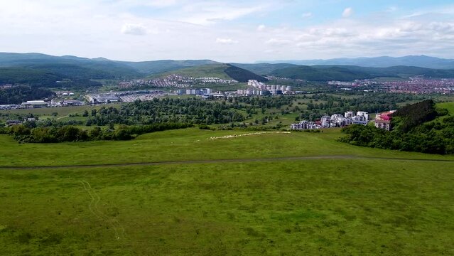 Drone view over a part of the Floresti village and a herd of sheep walking around.