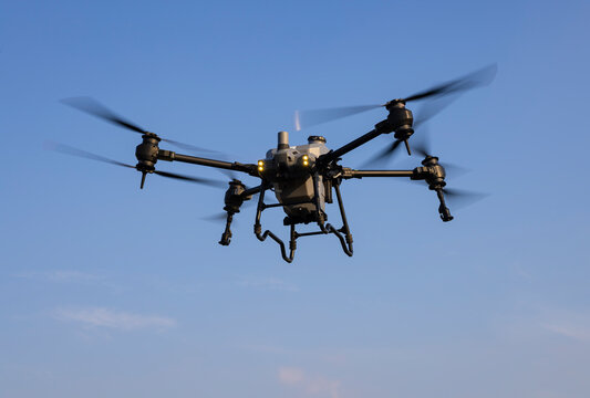 Agriculture drone flying in the blue sky background