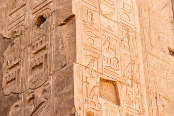 hieroglyphs carved in sandstone wall in Karnak temple in Luxor. Egyptian heritage and history concept