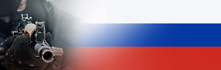 A machine gun in the hands of a Russian soldier on the background of the Russian flag. Blurred...