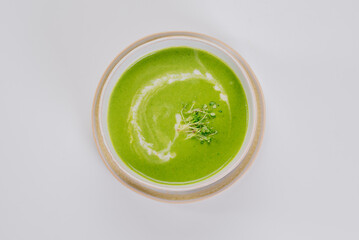 Dish of spinach cream soup and greens. Close up