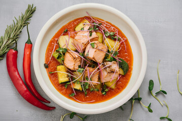 Red fish dish with zucchini and tomato sauce