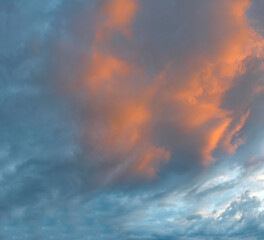 Russia. The South of Eastern Siberia. Gloomy sunset clouds in the evening summer sky over the mountain ranges of Eastern Sayan.