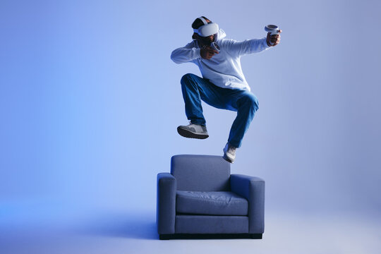 Energetic young man playing a virtual reality game