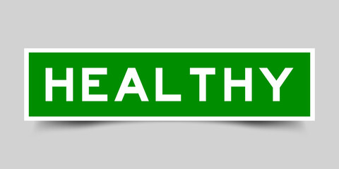 Sticker label with word healthy in green color on gray background