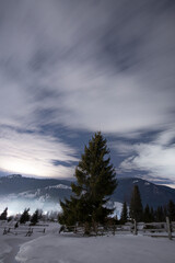 Amazing view on the starry night in the mountains village in Ukraine