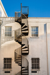 Fototapeta premium Building exterior with windows and wrought iron spiral staircase