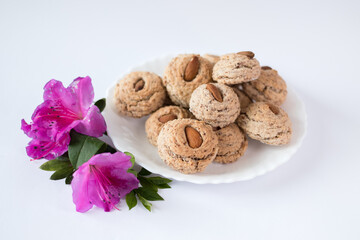 Almendrados, dumplings or typical biscuits made from almonds, sugar and egg white. Almond cakes on white background.