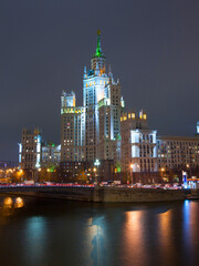 Evening picture of high building on river bank. Moscow, Russia