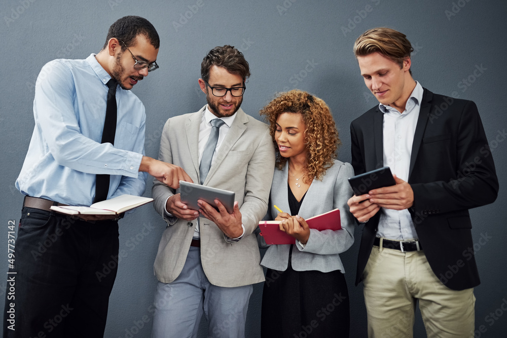 Poster Whats that. Cropped shot of a group of businesspeople using digital tablets and notebooks while waiting in line for a job interview.
