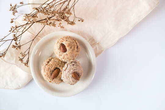 Almendrados, dumplings or typical biscuits made from almonds, sugar and egg whites. Almond cakes on white background.
