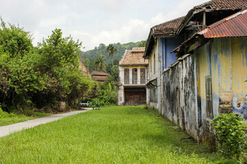 Fototapeta na wymiar A vintage colonial era house with a green garden in the village of Papan near Ipoh in Malaysia.