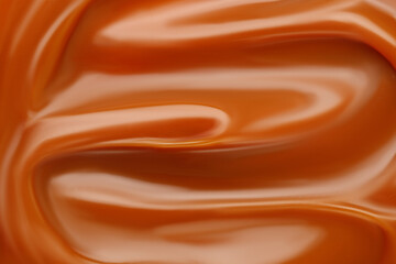 Liquid caramel syrup. Background of caramel paste. Texture Close up, top view. - obrazy, fototapety, plakaty