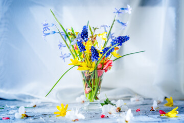 bouquet of bright spring flowers on the table, background, spring morning