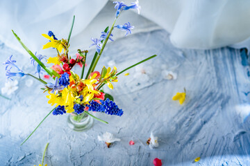 bouquet of bright spring flowers on the table, background, spring morning