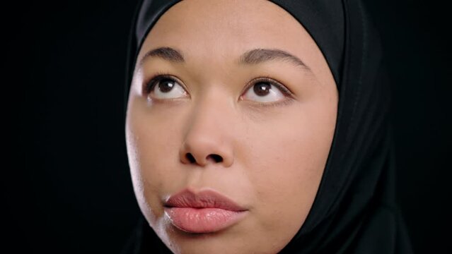 Black muslim woman in hijab praying, women's rights in Islam, feminism