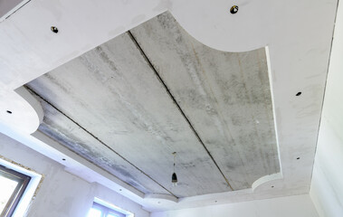 Installation of a two-level ceiling with lighting, floors of reinforced concrete slabs