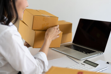 E-commerce startup is working in a home office while preparing parcels for delivery.
