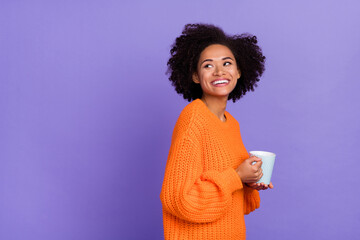 Portrait of attractive cheerful girl drinking cacao look aside copy space advert isolated over bright purple violet color background