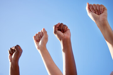 We must always take sides. Shot of an unrecognisable group of women raising their hands in strength...