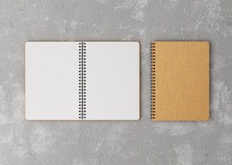 Mockup is an open white notebook next to a craft notebook. Mockup craft and white notebook on a gray background. 3D illustration.