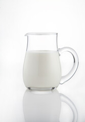 Natural whole milk in a jug  isolated on a white background 