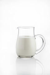 Natural whole milk in a jug  isolated on a white background 