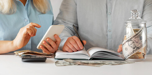 Fototapeta premium Person calculating the budget on phone