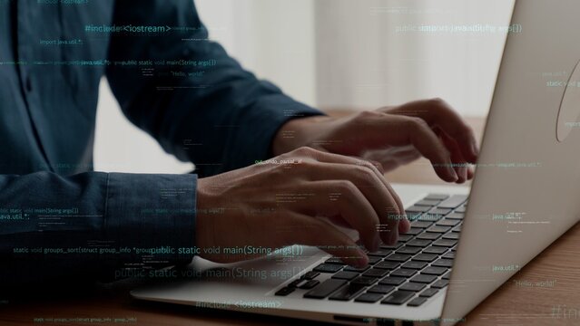 Computer programmer uses capable laptop computer to develop programming code of new software . Computer specialist working on future coding application for software programming development .