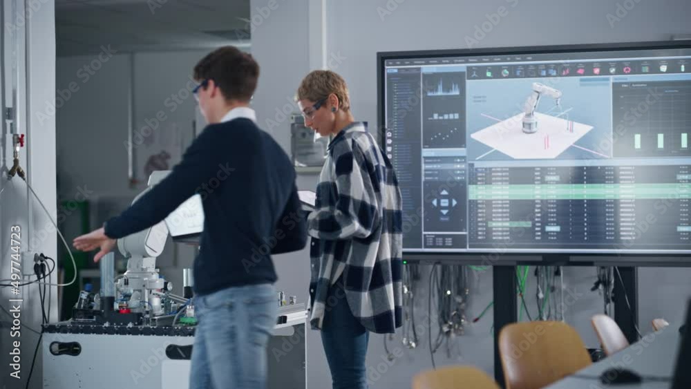 Poster students touching details of robotic hand and examining it during laboratory at university. they cel