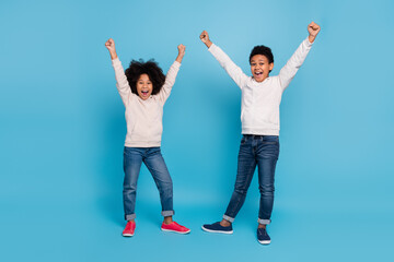 Full length body size view of attractive friends friendship rising hands up having fun isolated over bright blue color background