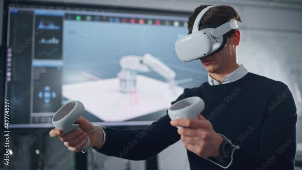 Aufkleber male student in virtual reality headset holding controllers and remotely moving robotic limb. action