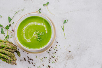 Dish of spinach cream soup and greens. Close up