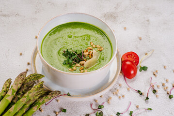 Dish of spinach cream soup and greens. Close up