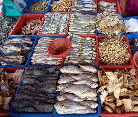 Baskets of fresh fish and sea food at an asian street market in Kuala Lumpur Malaysia.