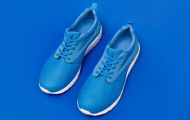 pair of comfortable blue sport shoes on blue background, sport fashion