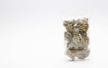 Plastic hermetic bag with set of marijuana buds, white background. Space for text